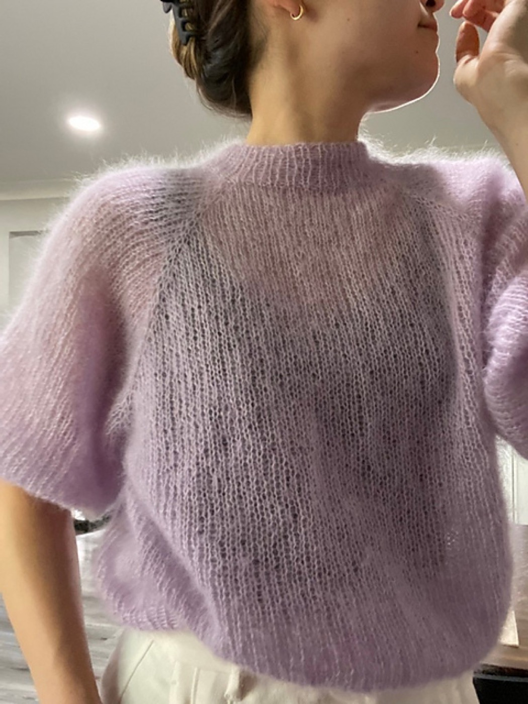 Detail photo of the lavender mohair sweater being worn.